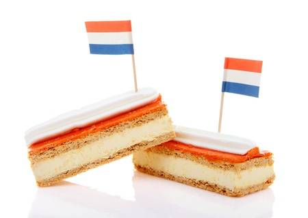 20008557-two-traditional-dutch-pastry-called-tompouce-with-flags-over-white-background